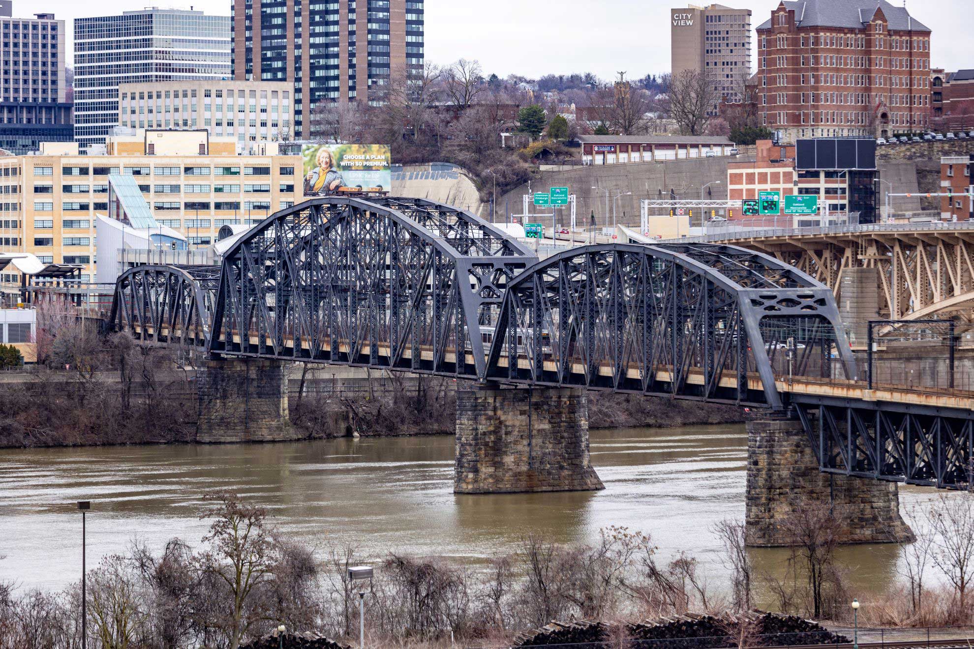 A light-rail car traveling over the Panhandle Bridge
